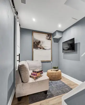 a living room with a couch and a table at Instaworthy Home - Relaxing Patio - Hot tub & BBQ in Cambridge