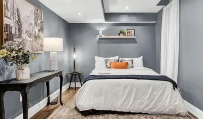 a bedroom with a bed and a desk in it at Instaworthy Home - Relaxing Patio - Hot tub & BBQ in Cambridge