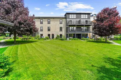 a large building with a large lawn in front of it at The Wynford Elora The Monroe Suite in Elora