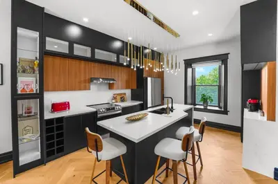 a kitchen with a large white island in a room at The Wynford Elora The Monroe Suite in Elora