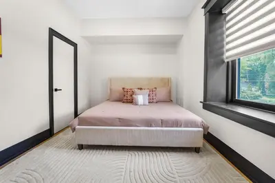 a bedroom with a bed with a large window at The Wynford Elora The Monroe Suite in Elora