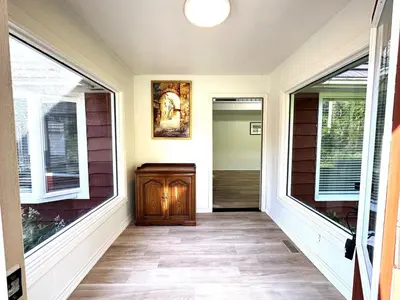 a hallway of a home with two large windows at Four and half bedrooms 10 Acres of forest with trails in Tottenham