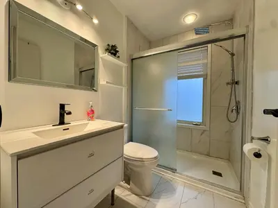 a bathroom with a sink and a shower and a toilet at Four and half bedrooms 10 Acres of forest with trails in Tottenham