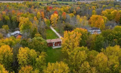 an aerial view of a house in the middle of a forest at Four and half bedrooms 10 Acres of forest with trails in Tottenham