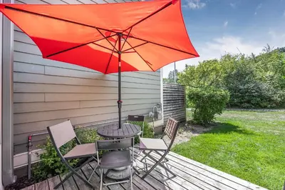 a table and chairs with an umbrella on a deck at Blue Mountain Haus - Private Patio - Walk to Blue in Blue Mountains
