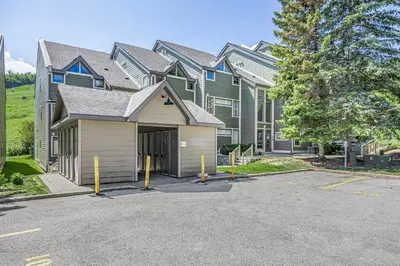 a large house with a parking lot in front of it at Blue Mountain Haus - Private Patio - Walk to Blue in Blue Mountains