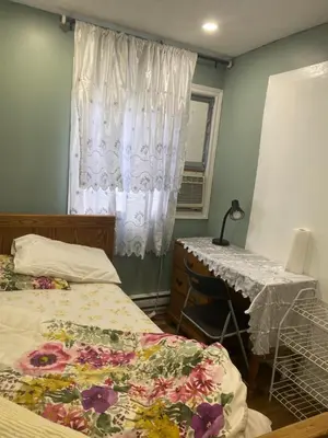 a bedroom with two beds and a desk and a window at Peaceful and Private Room in Brampton