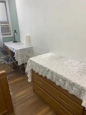 a room with two beds and a table and a chair at Peaceful and Private Room in Brampton