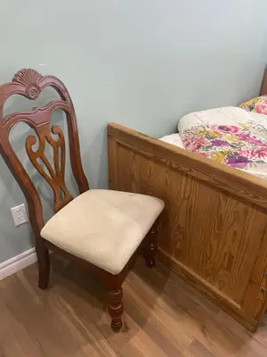 a chair in a room next to a bed at Peaceful and Private Room in Brampton