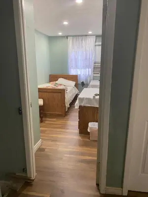 a hallway with two beds in a room with a window at Peaceful and Private Room in Brampton