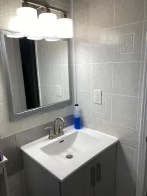 a bathroom with a sink and a mirror at Peaceful and Private Room in Brampton