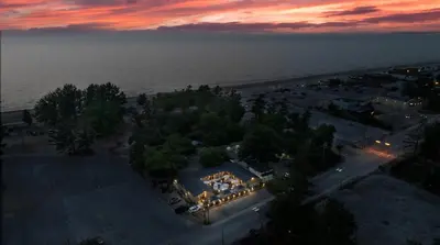 an overhead view of a beach with a house with lights at Adrian's Suites 2 Bedroom Family Suite in Wasaga Beach
