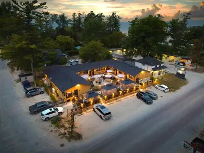 an overhead view of a house with cars parked in a parking lot at Adrian's Suites 1 Bedroom Junior Suite in Wasaga Beach