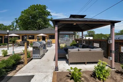 a gazebo with a couch on a patio at Adrian's Suites 1 Bedroom Junior Suite in Wasaga Beach