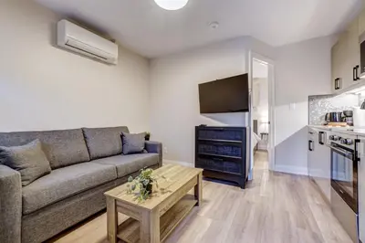 a living room with a couch and a table at Adrian's Suites 1 Bedroom Junior Suite in Wasaga Beach