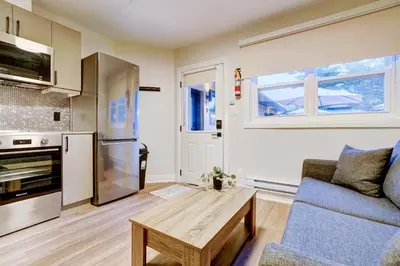a living room with a couch and a table at Adrian's Suites 1 Bedroom Junior Suite in Wasaga Beach