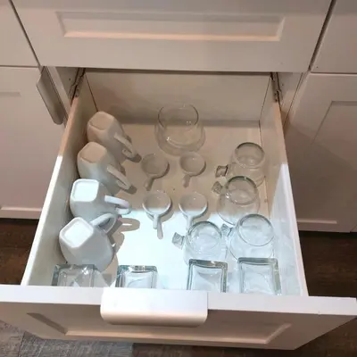 a drawer filled with cups and glasses in a cabinet at Compact,1BR Guesthouse Studio in Guelph