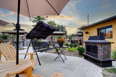 an umbrella sitting on a patio with a fireplace at Adrian's Suites 2Bedroom Family Suite in Wasaga Beach