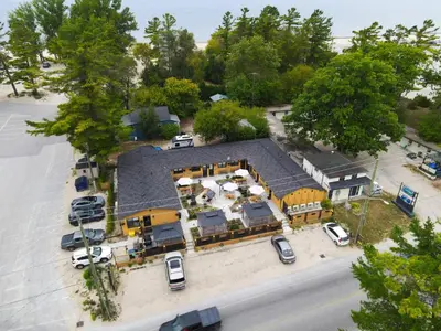 an aerial view of a house with a parking lot at Adrian's Suites 2 Bedroom Family Suite in Wasaga Beach