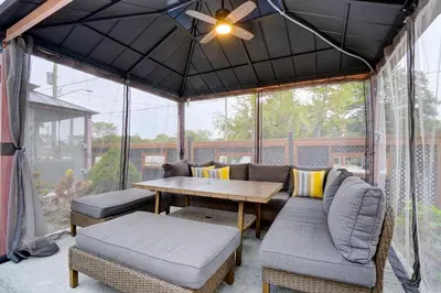 a screened in porch with a table and chairs at Adrian's Suites 2 Bedroom Family Suite in Wasaga Beach