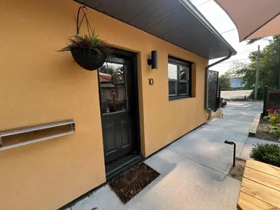 a door of a building with a plant on it at Adrian's Suites 2 Bedroom Family Suite in Wasaga Beach