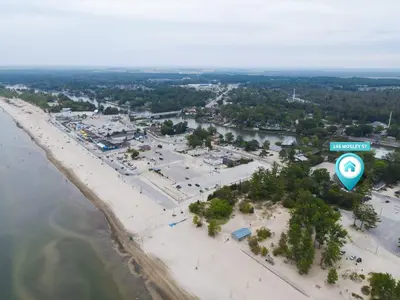 an aerial view of a beach with a sign at Adrian's Suites 2 Bedroom Family Suite in Wasaga Beach