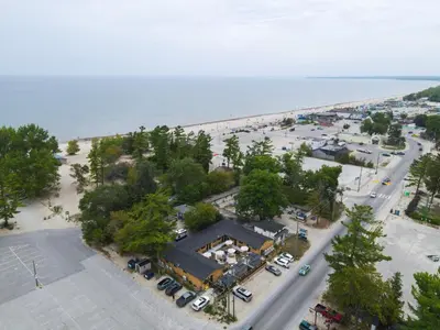 an aerial view of a parking lot next to a beach at Adrian's Suites 2 Bedroom Family Suite in Wasaga Beach