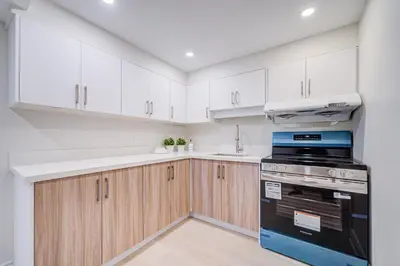 a kitchen with white cabinets and a stove top oven at nest in orchard-main unit room in Toronto