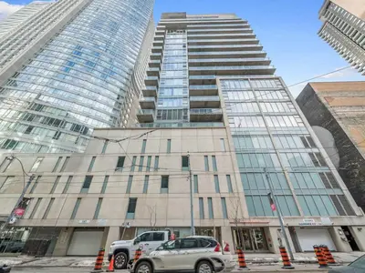 a truck parked in front of a building with tall buildings at Pantages Skyline Suite in Toronto Centre - Free Parking in Toronto