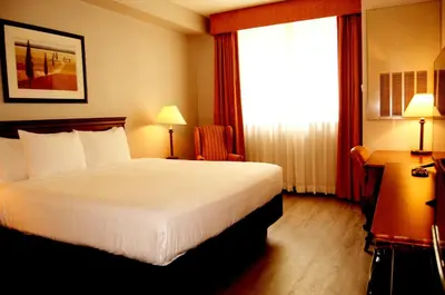 a hotel room with a bed and a window at Staywell Inn & Suites in London