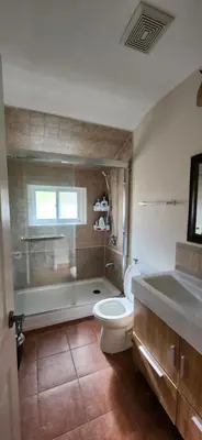 a bathroom with a toilet and a tub and a sink at Sunny Corner Room with View in Toronto