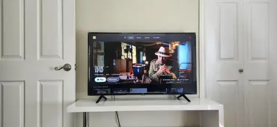 a flat screen tv sitting on a white stand at Sunny Corner Room with View in Toronto