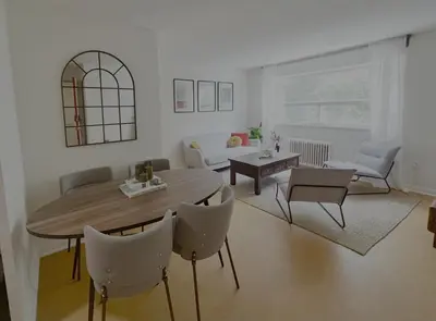 a living room with a table and chairs at Cozy Upper Beaches Apartment in Toronto