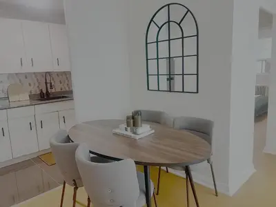 a kitchen with a wooden table and chairs at Cozy Upper Beaches Apartment in Toronto