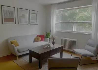 a living room with a couch and a coffee table at Cozy Upper Beaches Apartment in Toronto