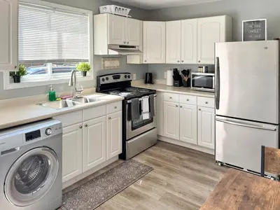 a kitchen with white cabinets and a white refrigerator at Cozy Retreat with Netflix and Work Desk in Fort Erie
