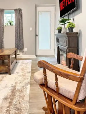 a living room with a chair and a fireplace at Cozy Retreat with Netflix and Work Desk in Fort Erie