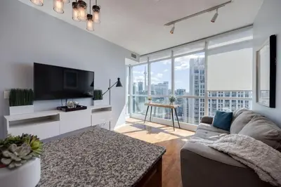 a living room with a couch and a large window at Ent District 3 Bedroom 2Bath Parking CN Tower in Toronto
