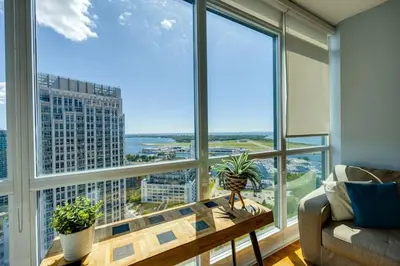 a living room with a table and large windows at Ent District 3 Bedroom 2Bath Parking CN Tower in Toronto