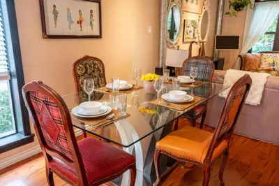 a dining room with a glass table and chairs at Stylish 2BR Home with Front Yard and Free Parking in Toronto