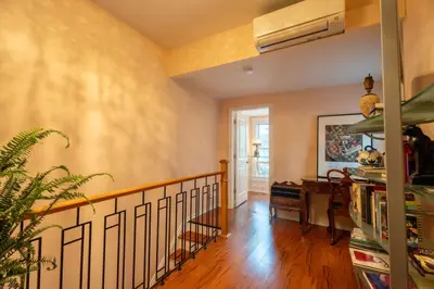 a living room with a staircase and a room with a desk at Stylish 2BR Home with Front Yard and Free Parking in Toronto