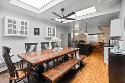 a kitchen and dining room with a wooden table and chairs at Beautiful home, a few minutes to the waterfall and attractions in Niagara Falls