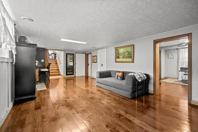 a living room with a couch and wooden floors at Beautiful home, a few minutes to the waterfall and attractions in Niagara Falls