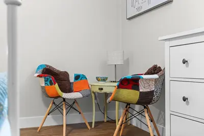 a bedroom with two chairs and a desk at Family-Friendly 2BR Near Lake & Downtown in Cobourg