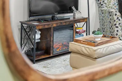 a living room with a fireplace and a television at Family-Friendly 2BR Near Lake & Downtown in Cobourg