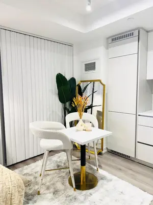 a living room with a white table and chairs at Bright & Cozy 1 Bedroom Retreat in Vaughan