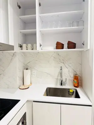 a kitchen with a sink and white cabinets at Bright & Cozy 1 Bedroom Retreat in Vaughan