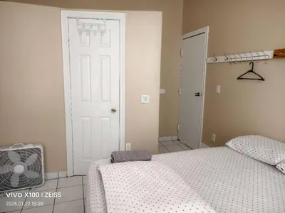 a bedroom with a bed and a white door at Toronto Travellers Home in Toronto