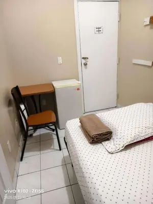 a bedroom with a bed and a desk and a chair at Toronto Travellers Home in Toronto