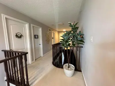 a hallway with a potted plant in a room at Luxurious Villa 3 Living Rooms, 1 sofa bed, 4 bedrooms, 4 Beds, 4 Toilets, 1 hour To Toronto in Oshawa